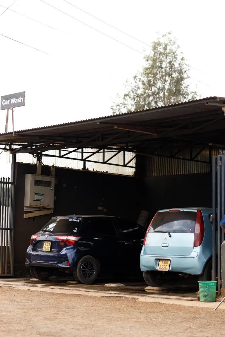 Cars under the wash bay canopy